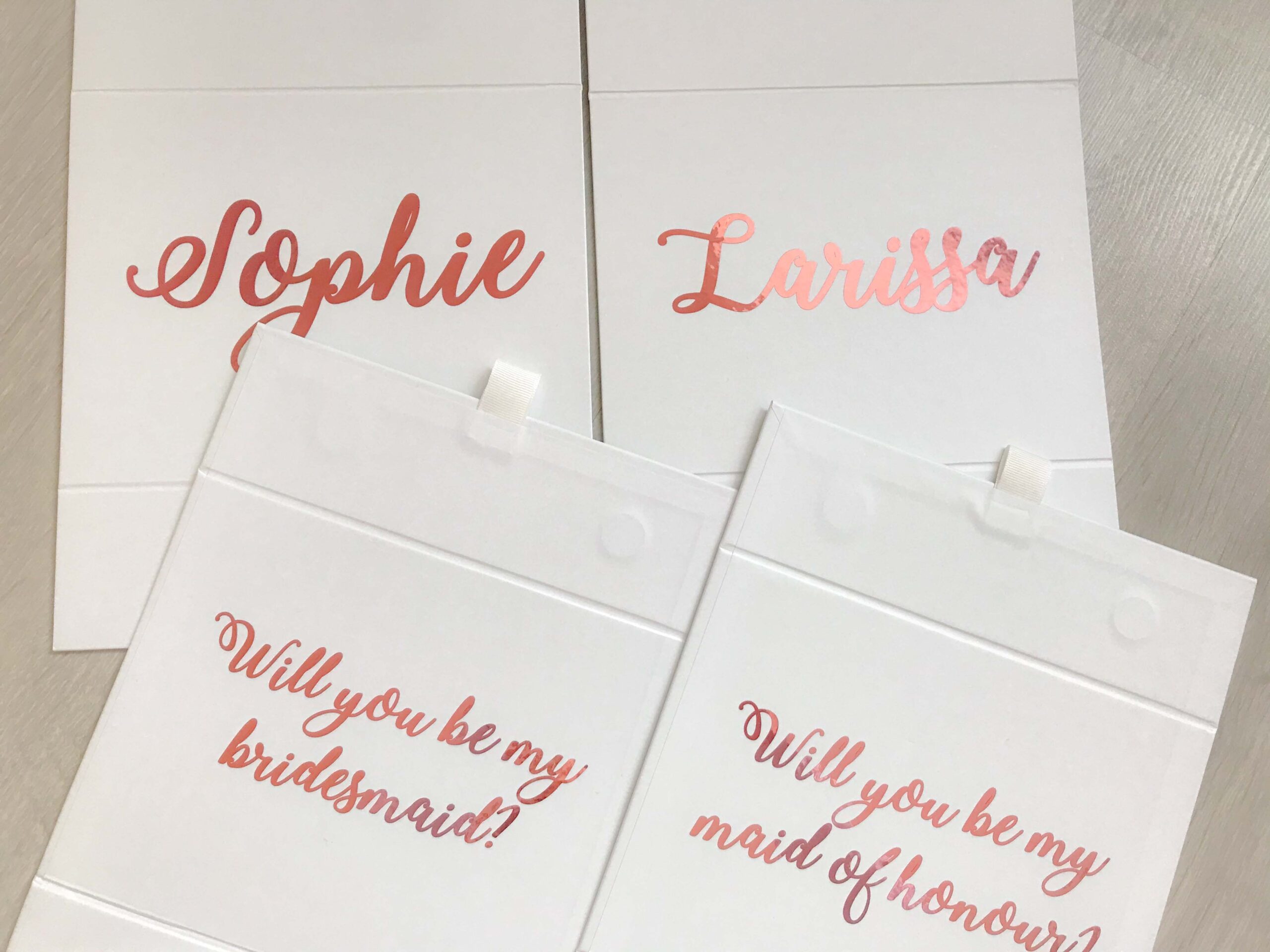 bridesmaid and maid of honour boxes with pink writing