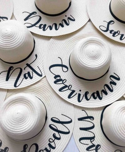 Natural wide brim personalised sun hats with custom names in script font – perfect for hen parties, honeymoons, and beach holidays.