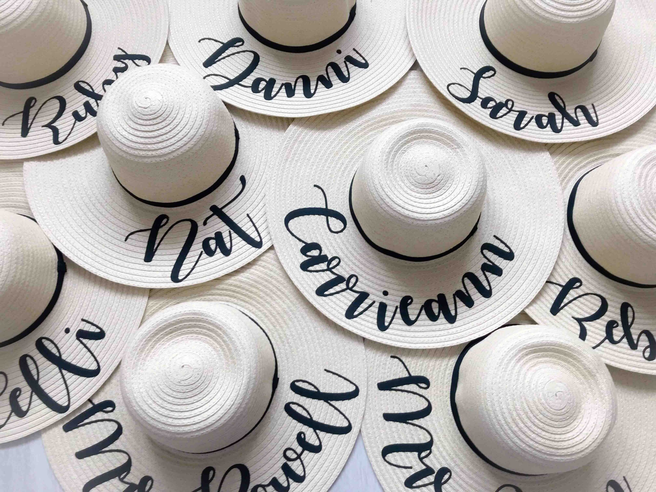 Natural wide brim personalised sun hats with custom names in script font – perfect for hen parties, honeymoons, and beach holidays.