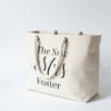 Personalised natural canvas tote bag featuring 'The New Mrs Foster' printed in black script, with thick rope handles, ideal for honeymoon or beach use