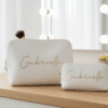 Personalised ivory makeup bags (large and small) with gold 'Gabrielle' script. Perfect as bridesmaid gifts, wedding favours, or custom bridal party accessories. Ideal for 'Will you be my bridesmaid?' proposals and bachelorette party keepsakes.