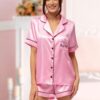Bride wearing personalised pink satin short pyjamas with monogram text