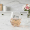 Personalised champagne glass with "Bridesmaid" written in gold script. The glass is filled with champagne in a relaxed, celebratory setting, perfect for wedding morning photos or bridesmaid gifts.